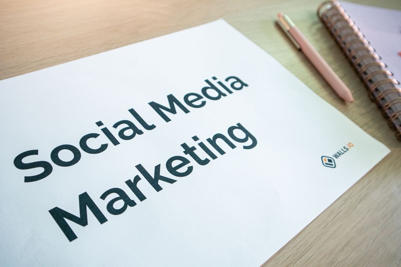 service-05 Close-up of a social media marketing document on a desk with a pen and notebook.
