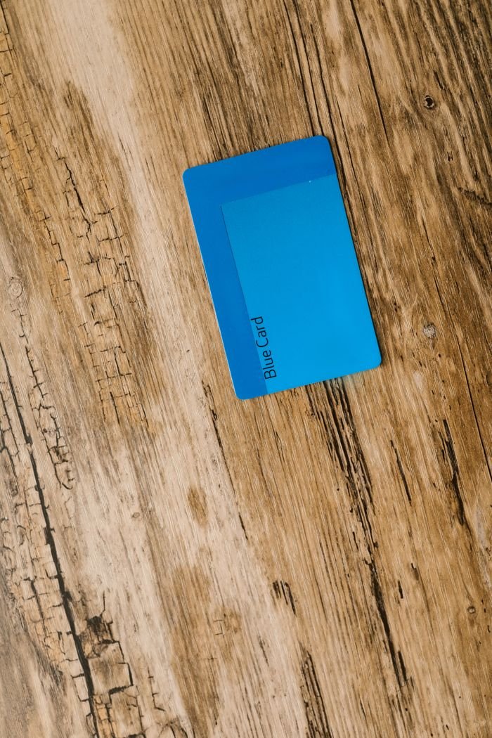 service-02 Top view of a blue card placed on a rustic wooden surface, ideal for business or technology themes.